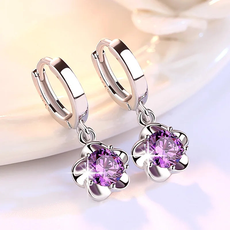Close-up of the purple gemstone on the sterling silver earrings, showing the color and clarity of the stone